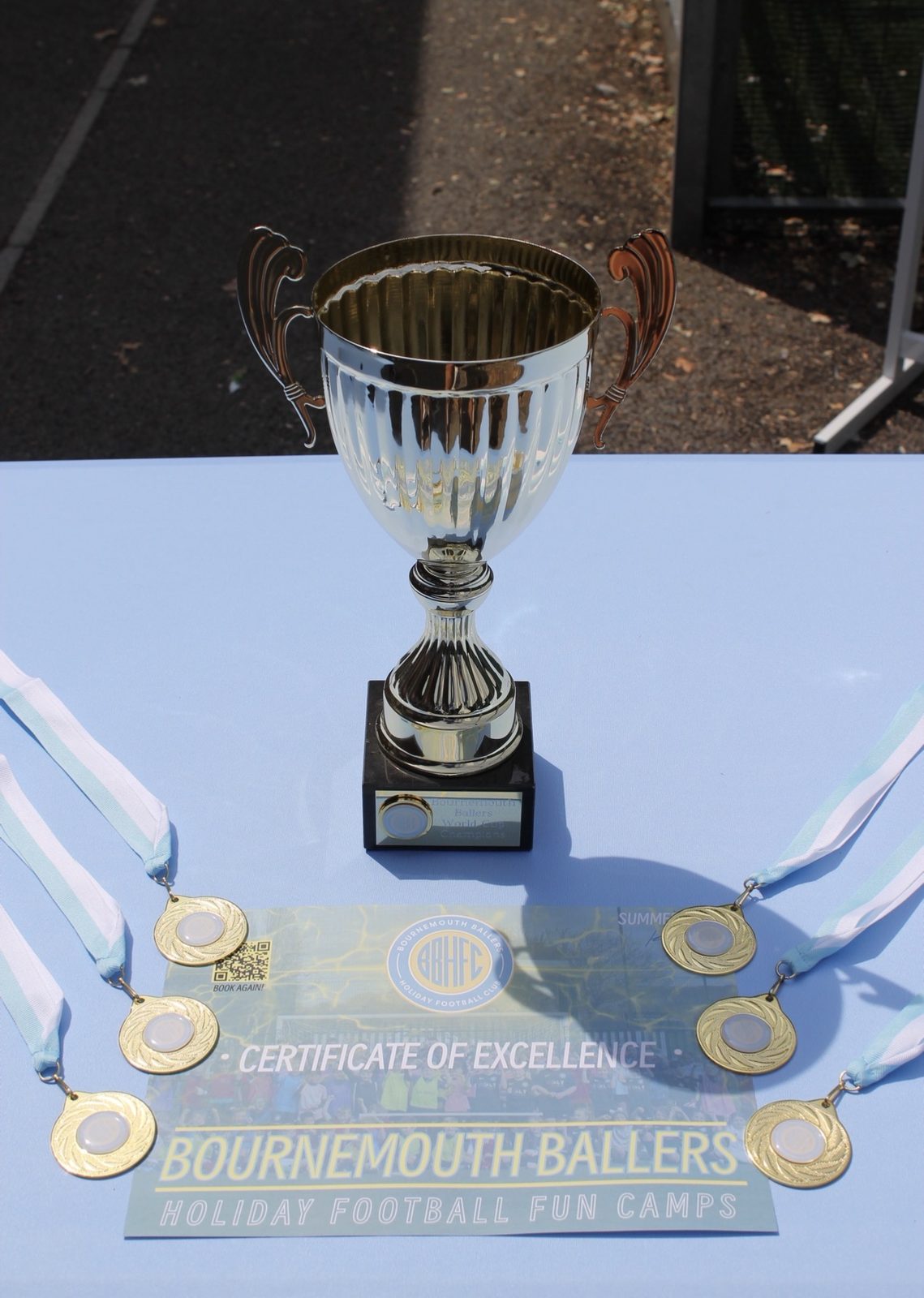 The Bournemouth Ballers trophy, medals and Certificate of Excellence on the presentation table
