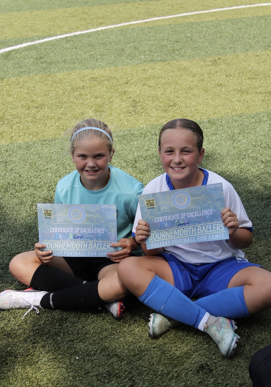 Two girls with their Certificates of Excellence at a Bournemouth Ballers girls-only summer camp, Pelhams Park